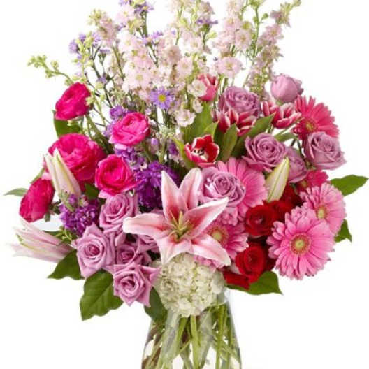 Mixed pink and purple bouquet in a clear glass vase