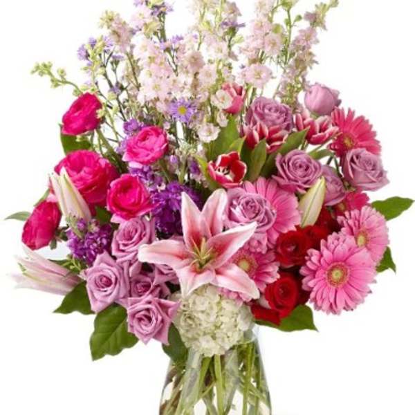 Mixed pink and purple bouquet in a clear glass vase
