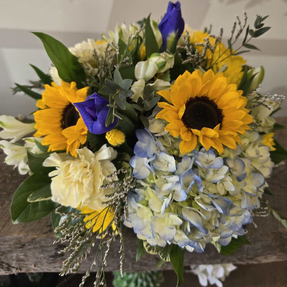 Bouquet with sunflowers, blue hydrangea, and white blooms