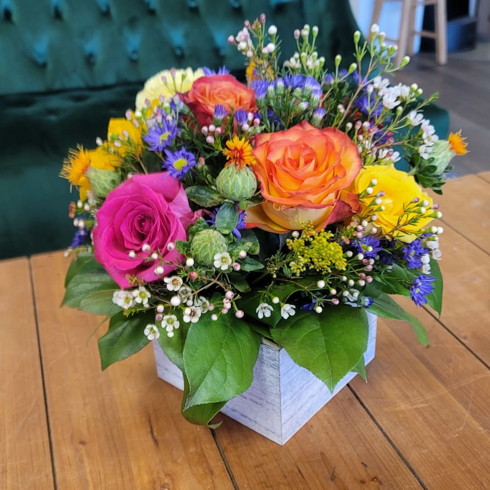 Colorful rose bouquet in a white square box