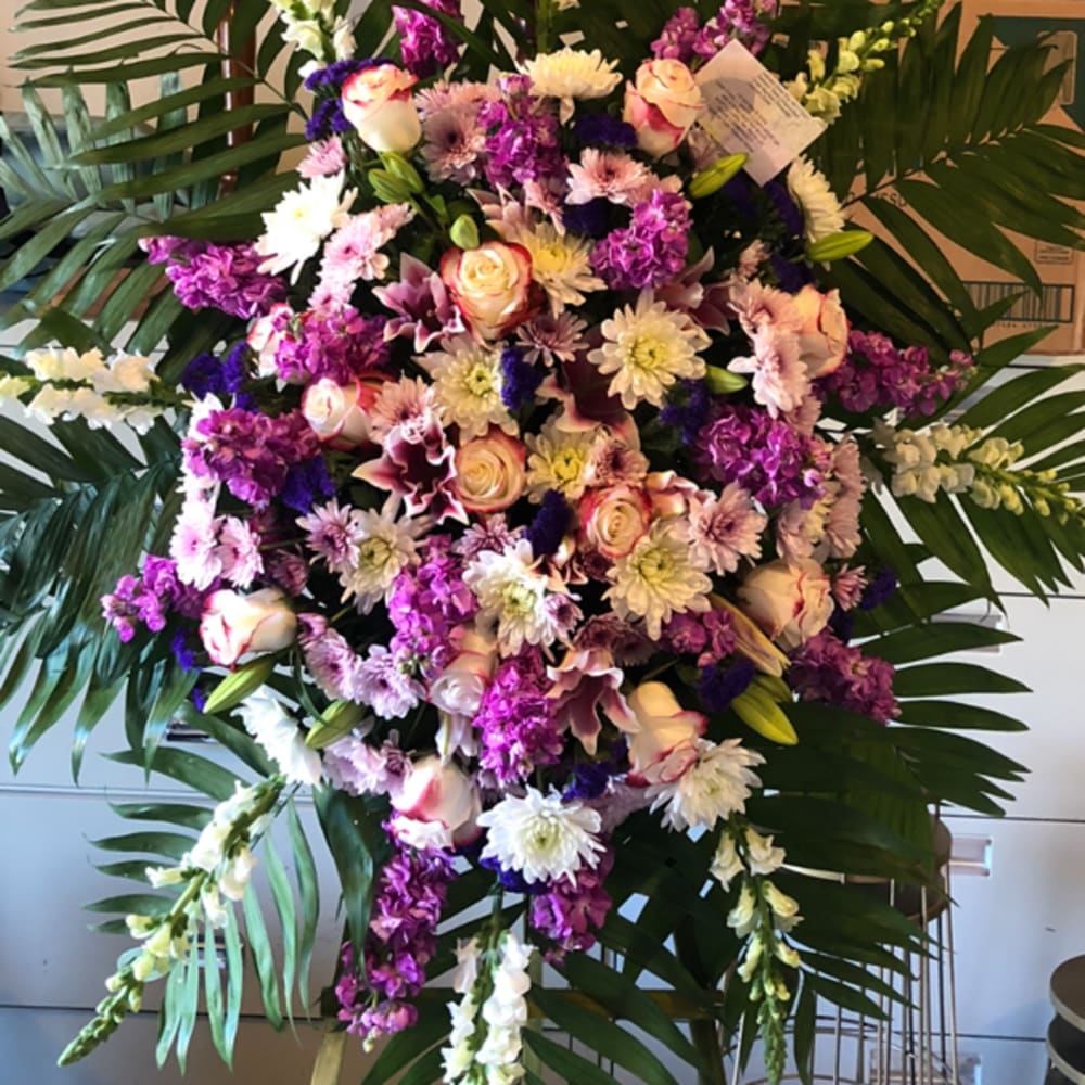Large standing floral spray with pink, white, and purple flowers