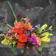 Bright mixed bouquet with red roses, lilies, and purple accents