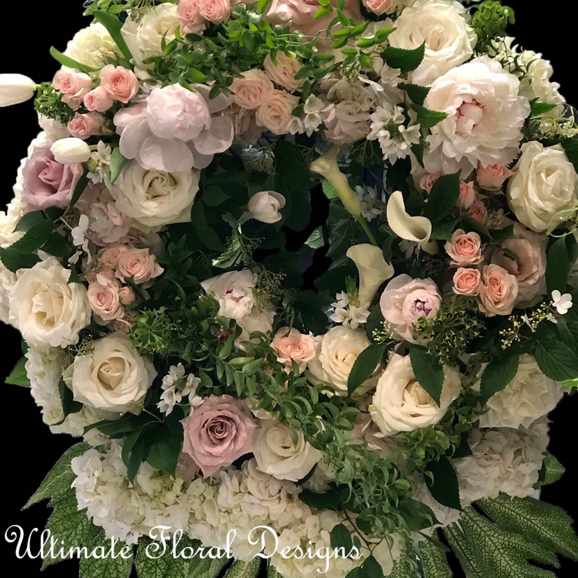 Large floral wreath of white and blush roses with greenery