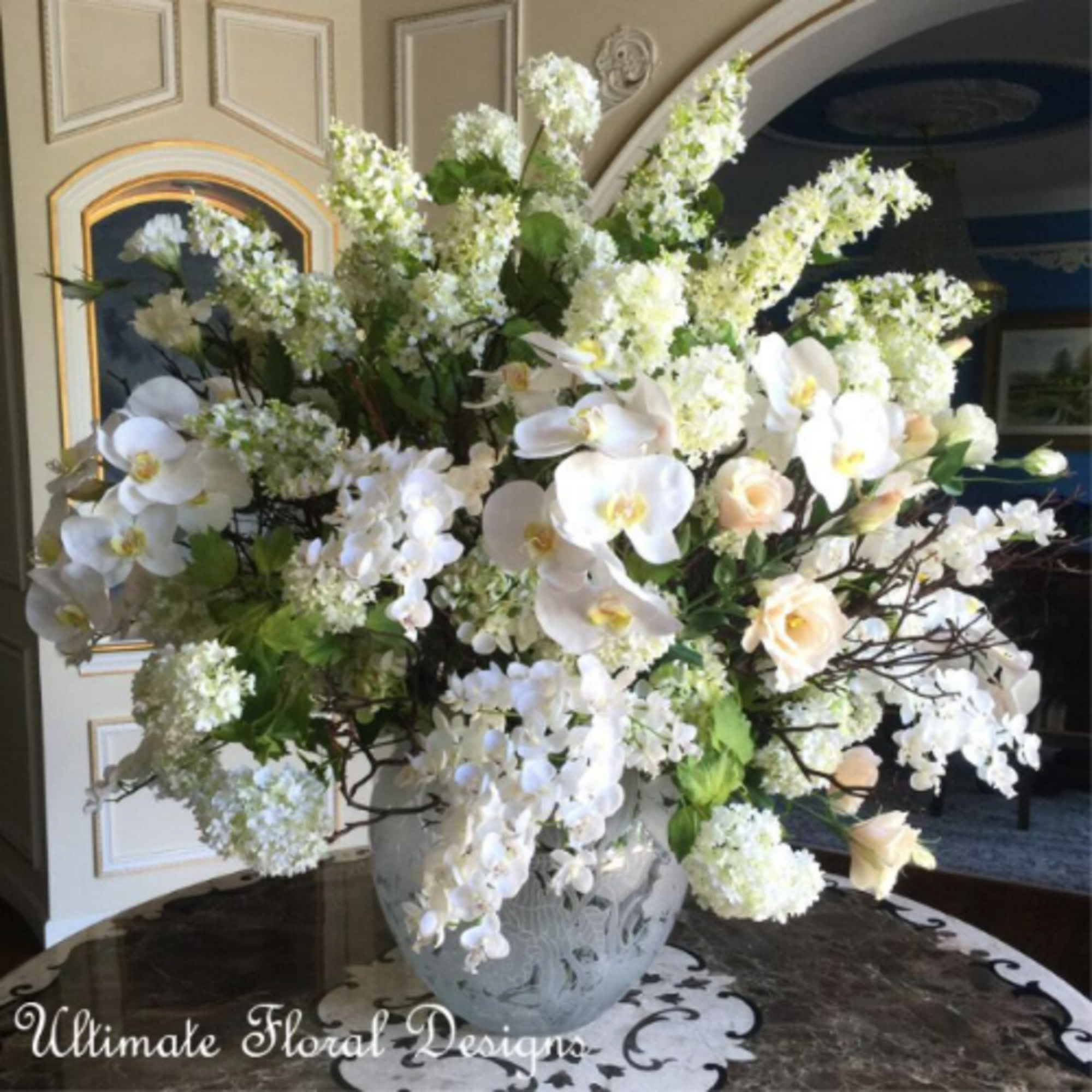 Large white floral arrangement in a decorative vase