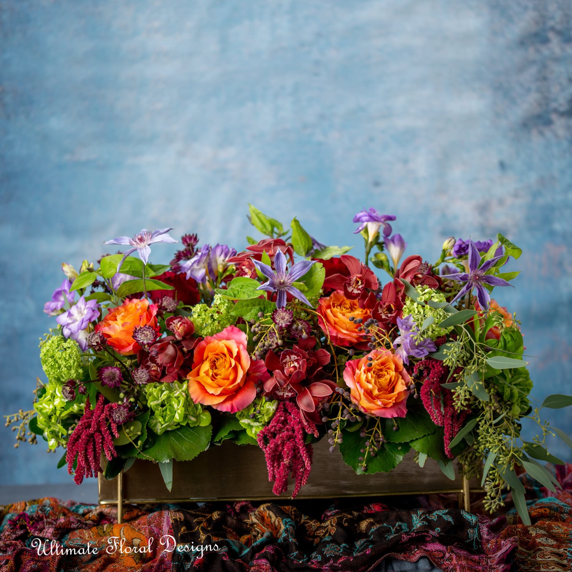 Colorful floral arrangement in a rectangular brass container