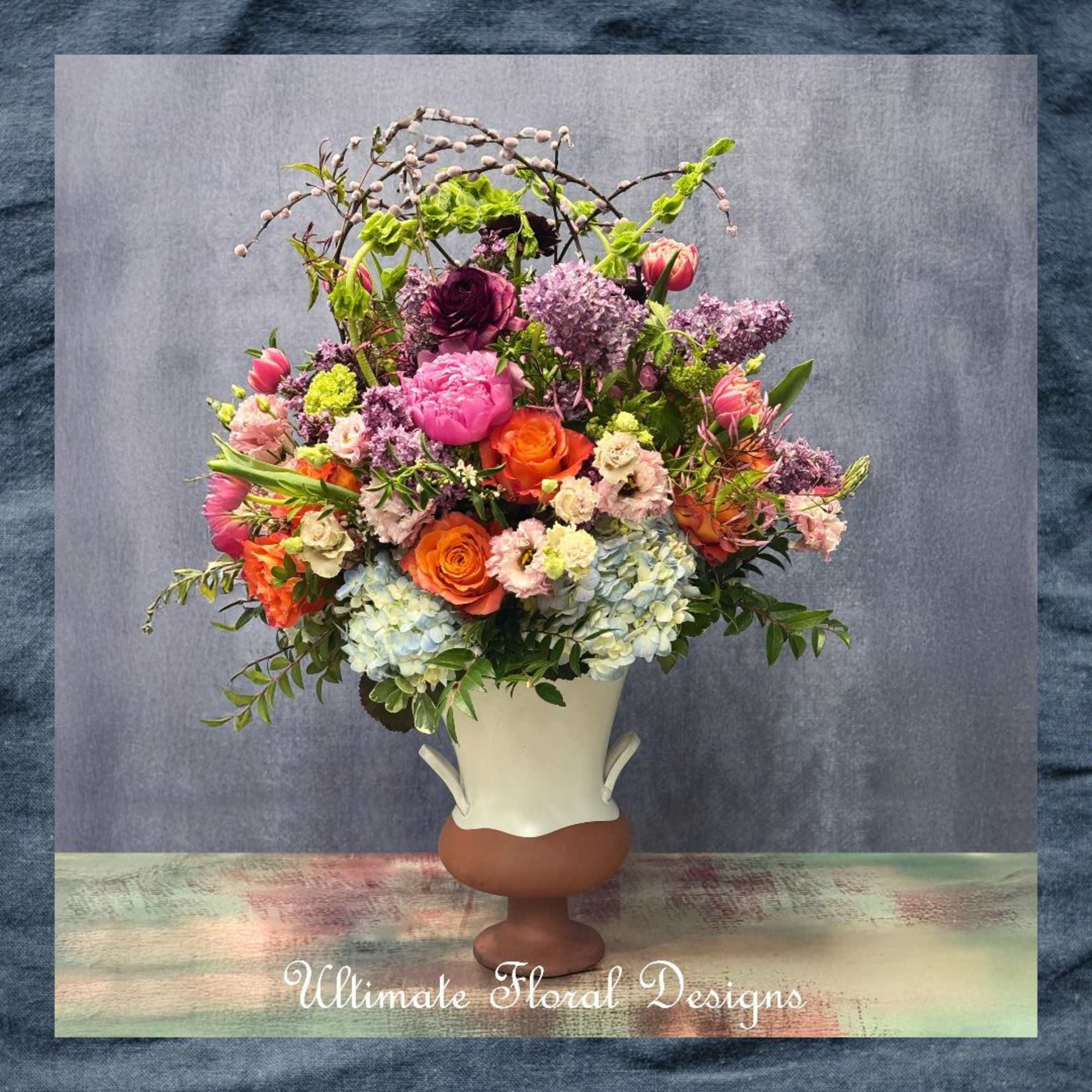 Colorful mixed bouquet in a white and brown vase