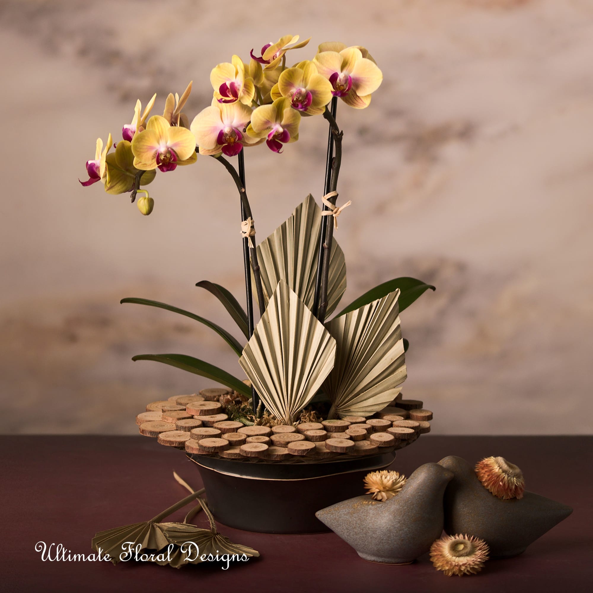 Yellow and purple orchids arranged in a low decorative bowl