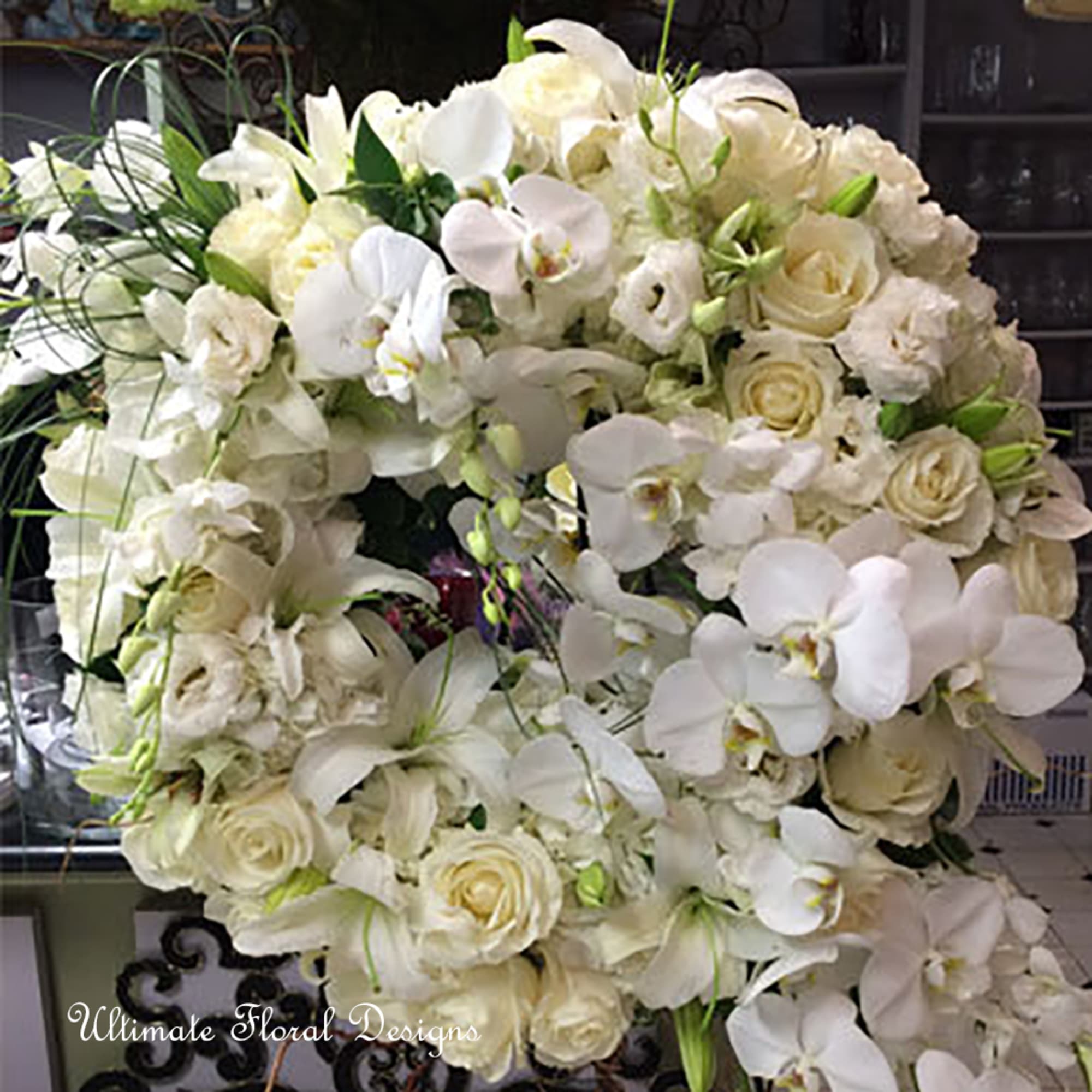 Large white floral wreath with roses and orchids