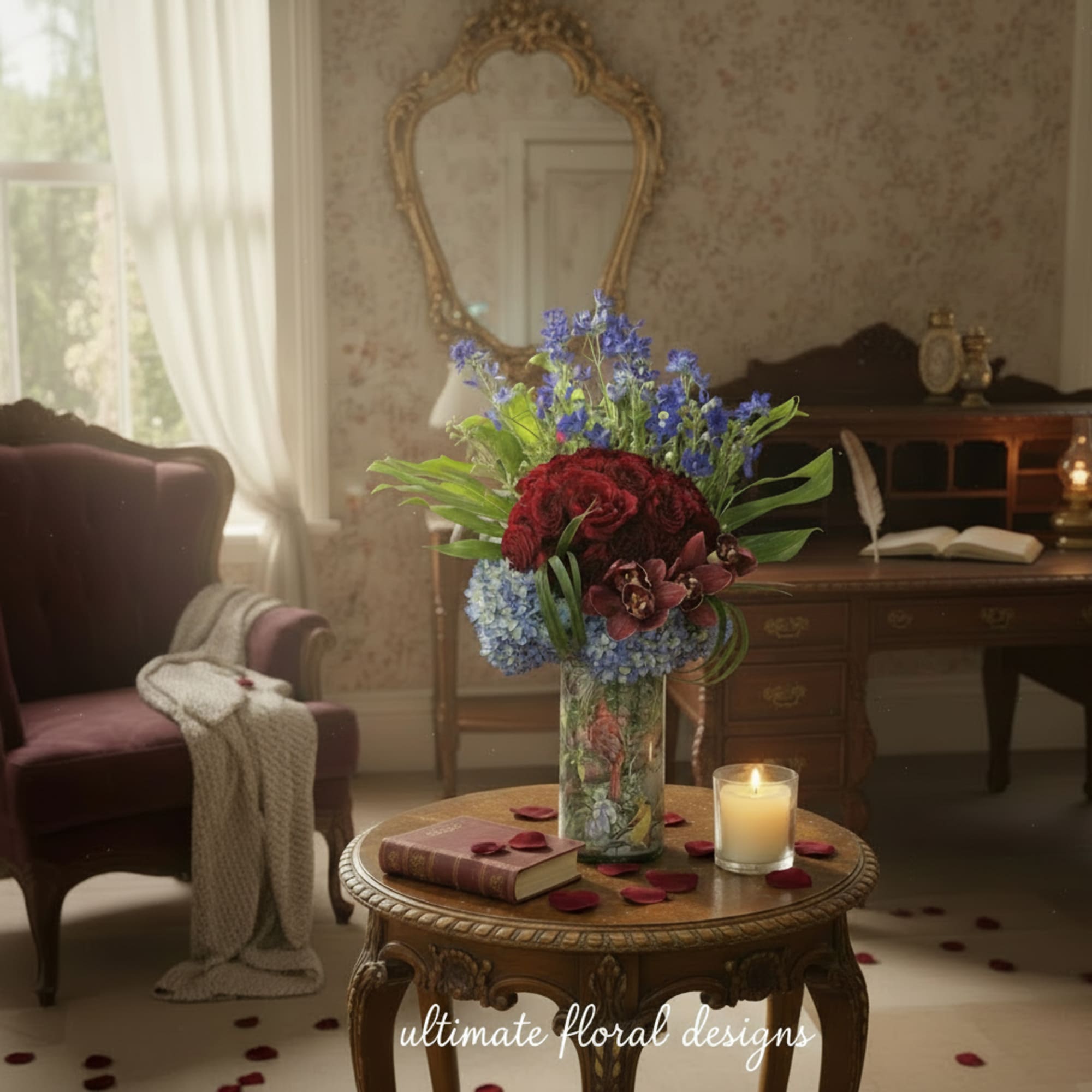 Tall mixed flower arrangement in a glass vase on a table with a candle and book