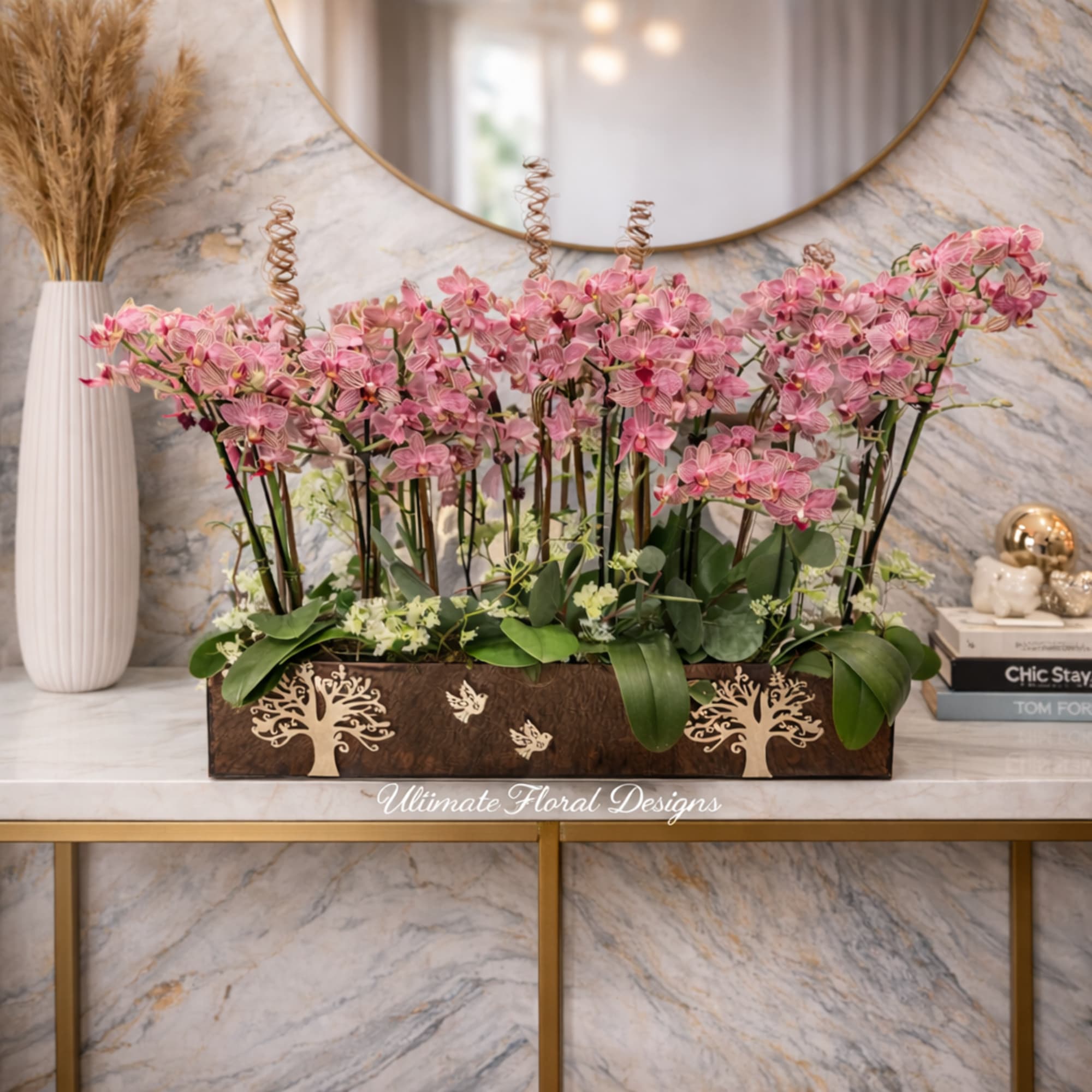 Pink orchid arrangement in a rectangular wooden planter
