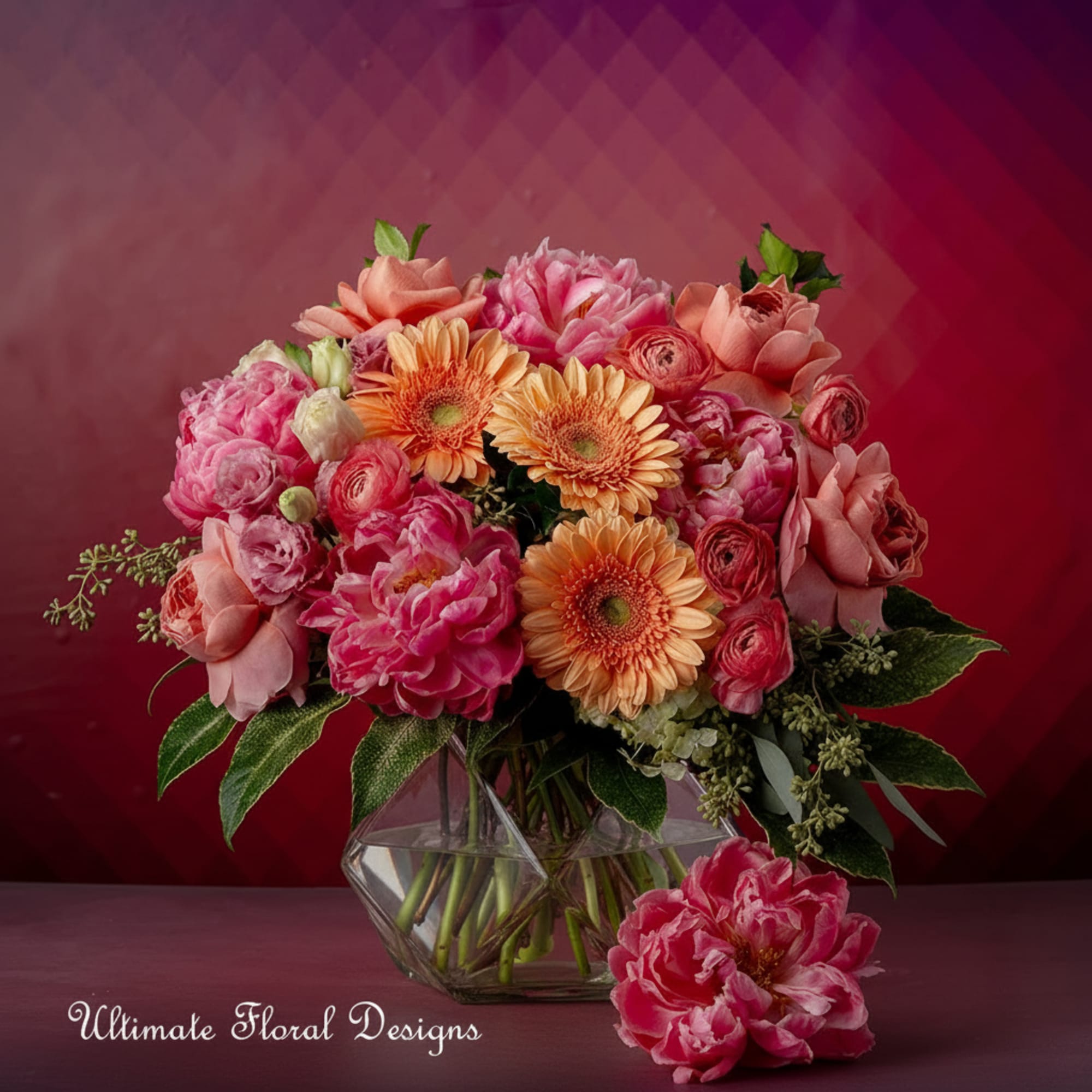 Pink and peach mixed bouquet in a geometric glass vase