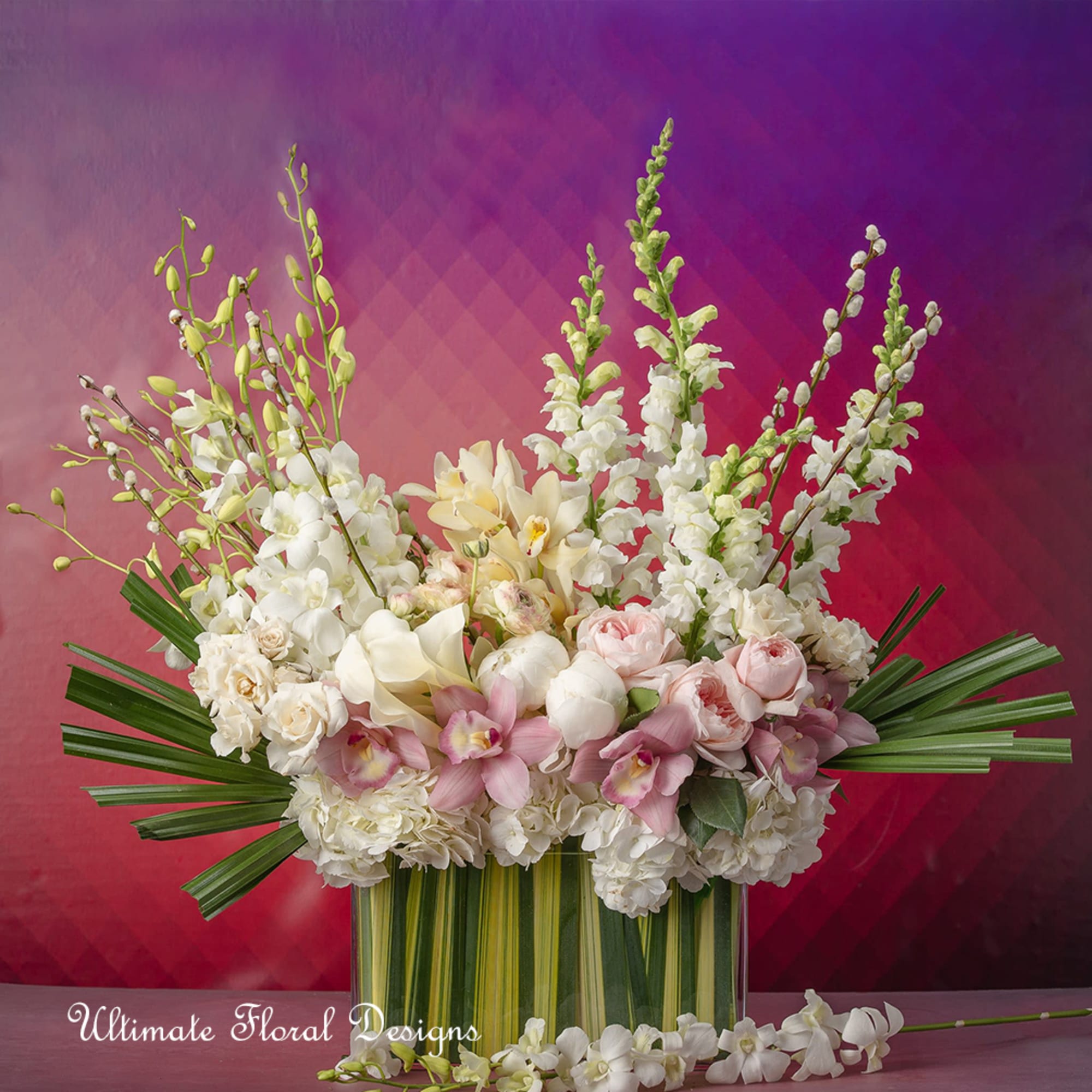 Large white and blush floral arrangement in a striped vase