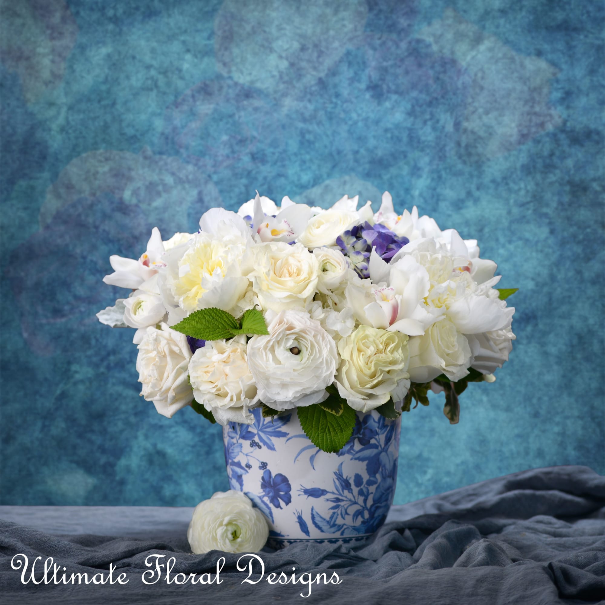 White floral arrangement in a blue-and-white ceramic vase