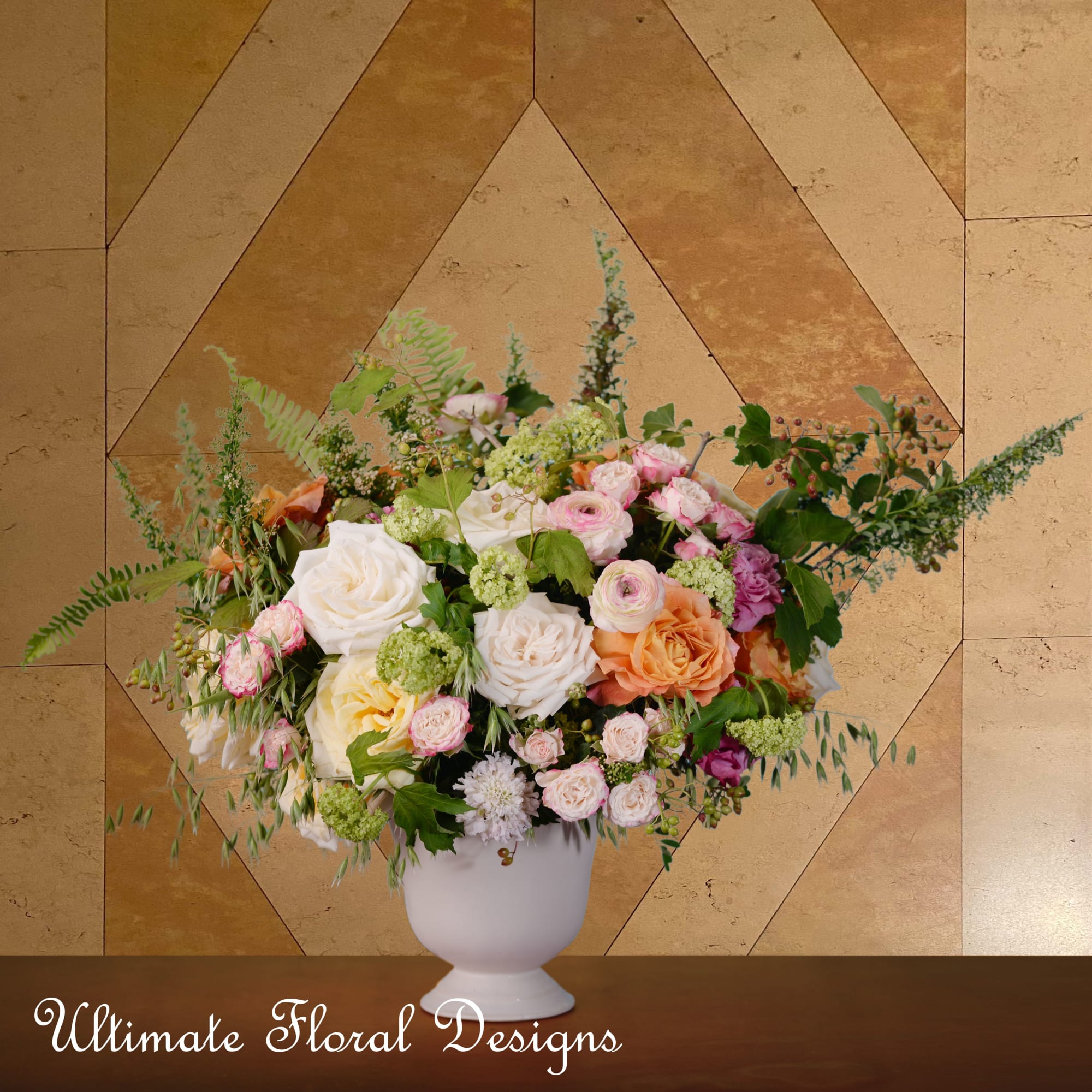 Mixed pink, white, and peach flowers in a white vase