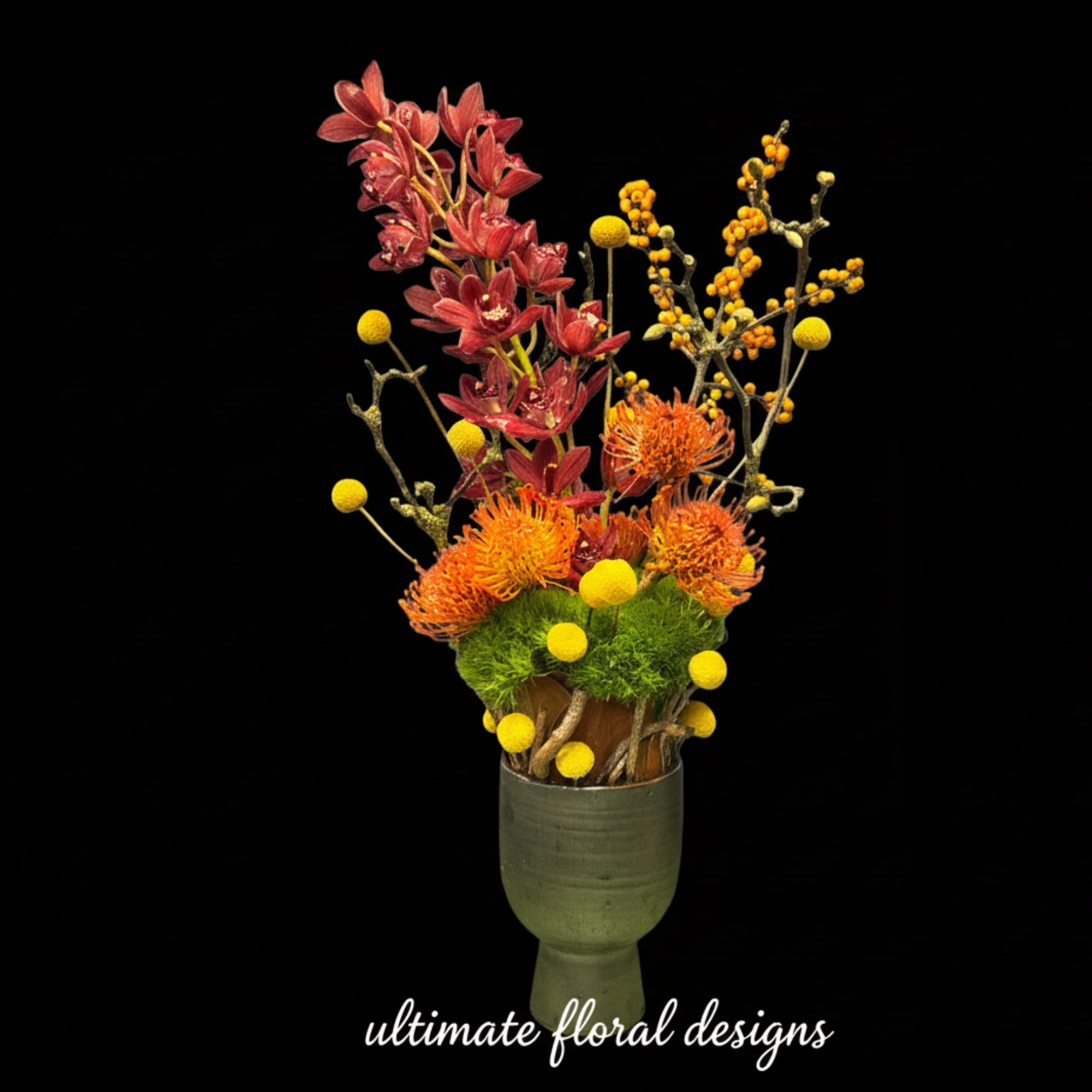 Tall floral arrangement with red and orange blooms in a green vase