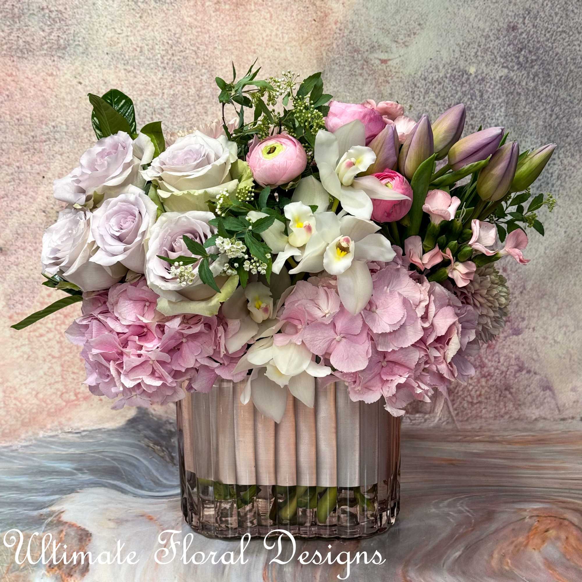 Pink and white floral arrangement in a clear glass vase