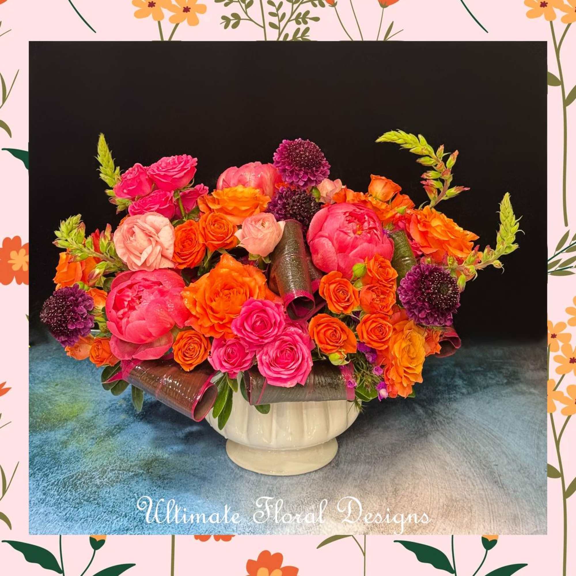 Bright pink and orange rose arrangement in a white vase