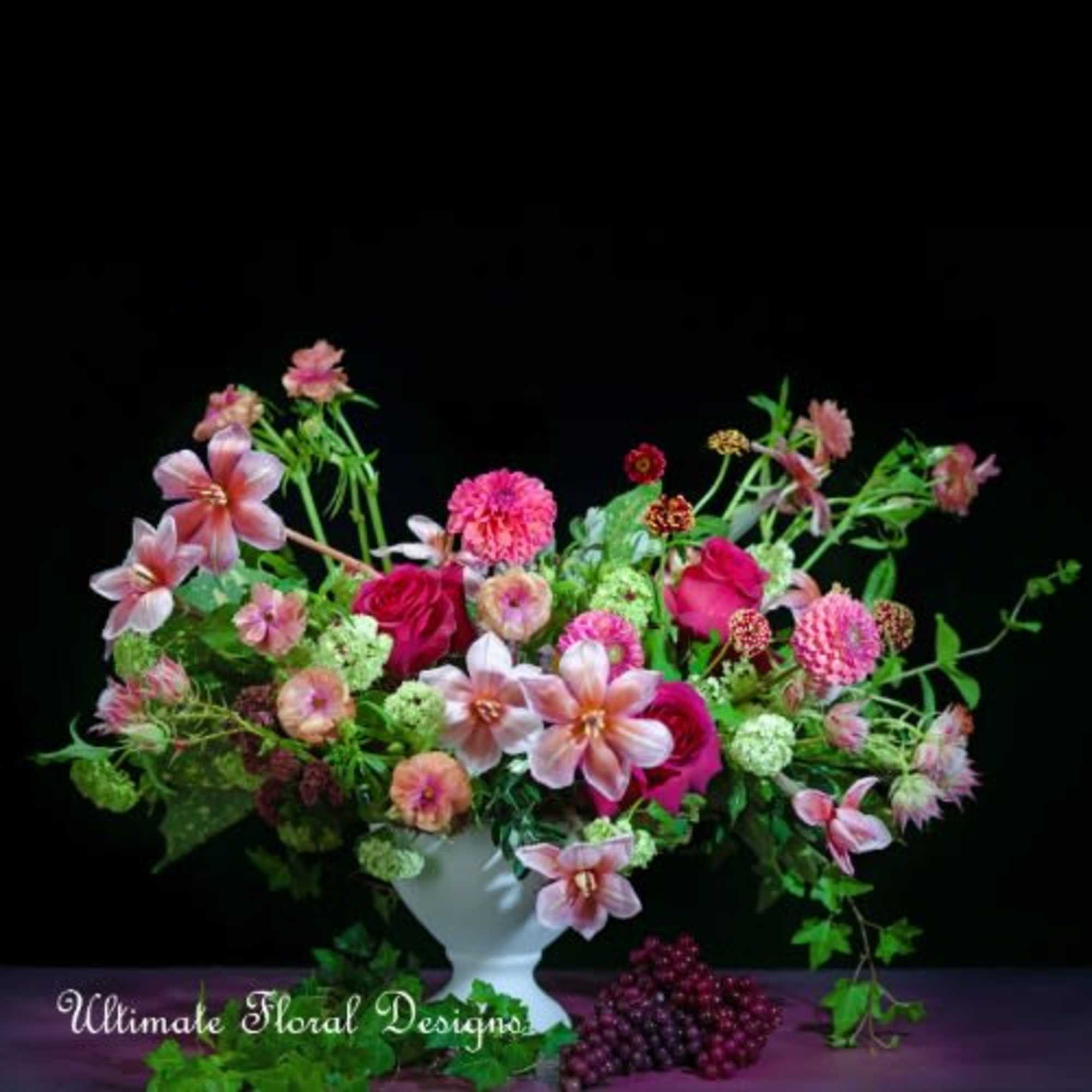 Mixed pink floral arrangement in a white vase