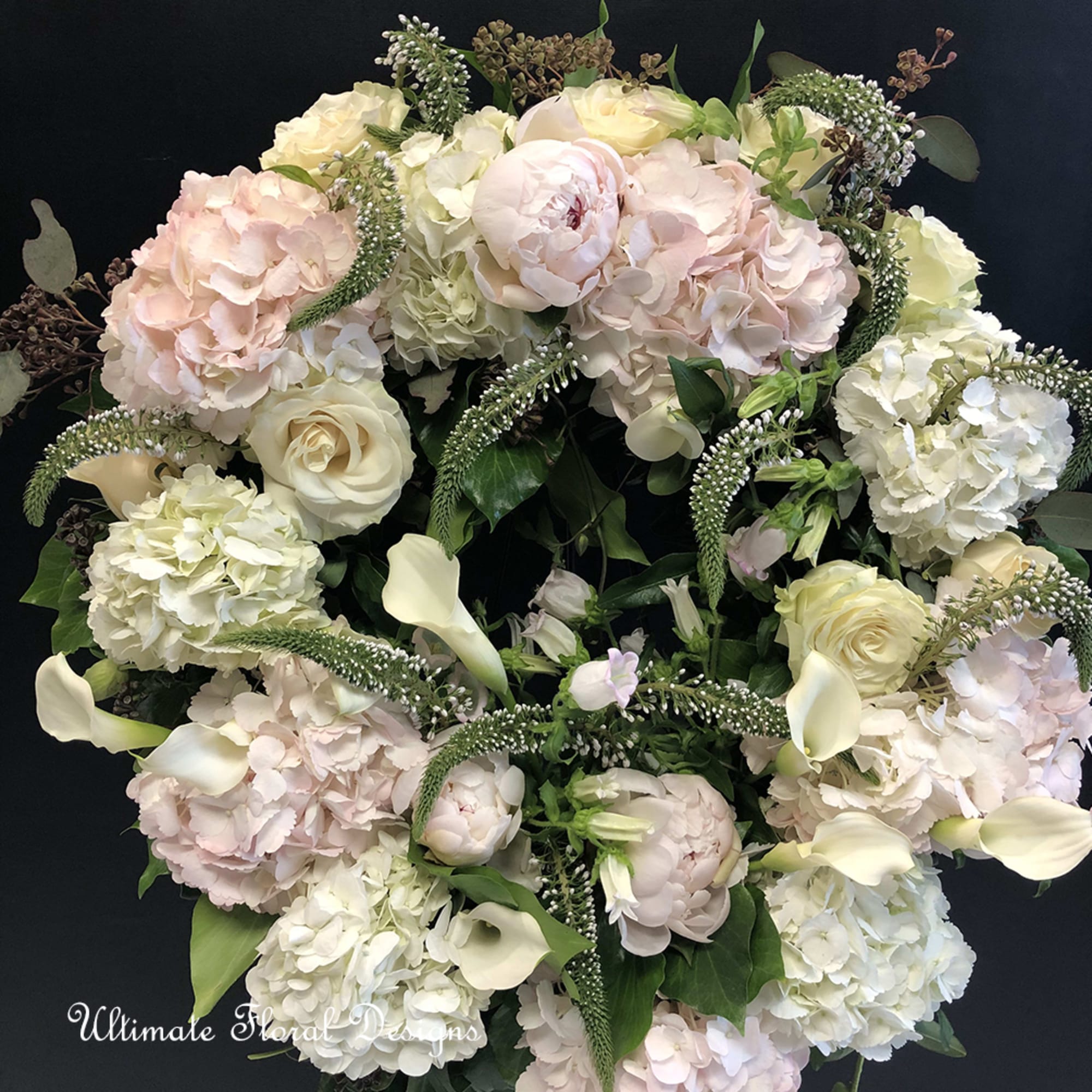 Bouquet of pale pink and white flowers with cream calla lilies