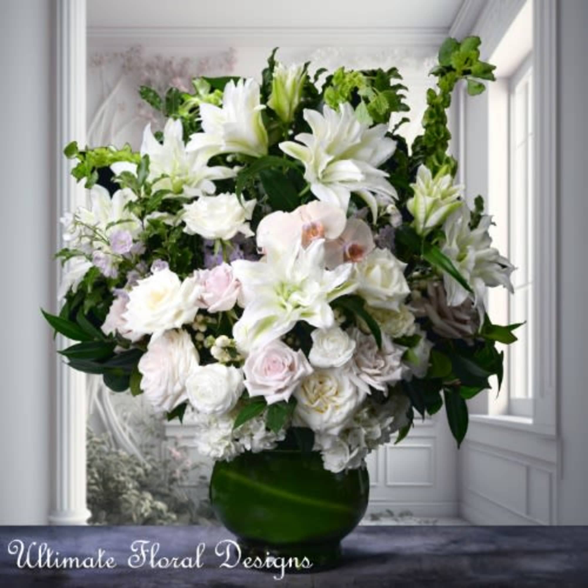 Large white floral arrangement in a green glass vase