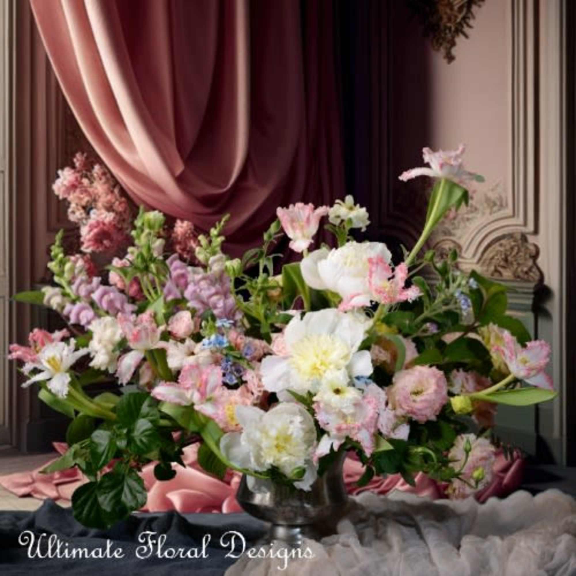 Large pastel floral arrangement in a silver vase with pink and white blooms