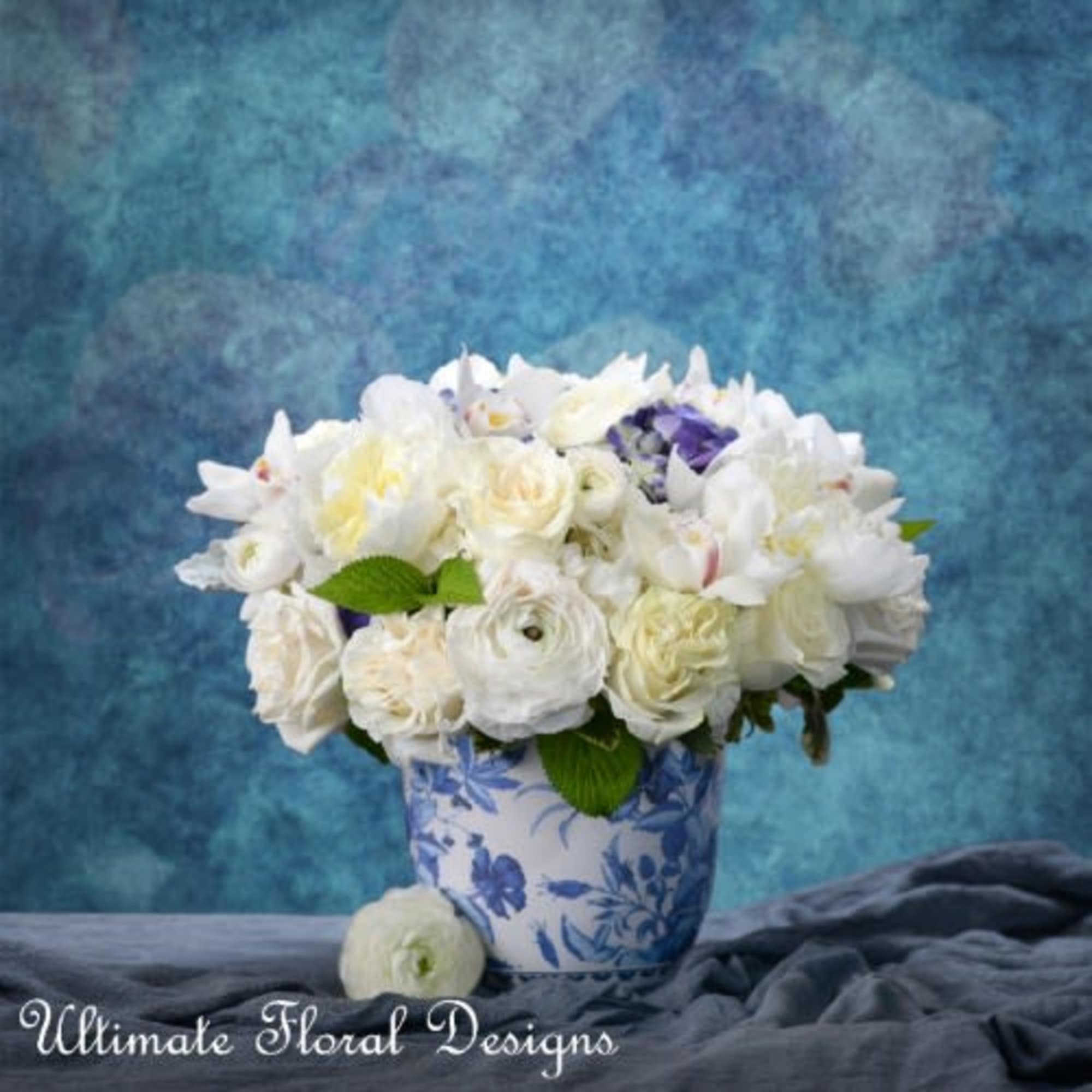 White floral bouquet in a blue-and-white ceramic vase
