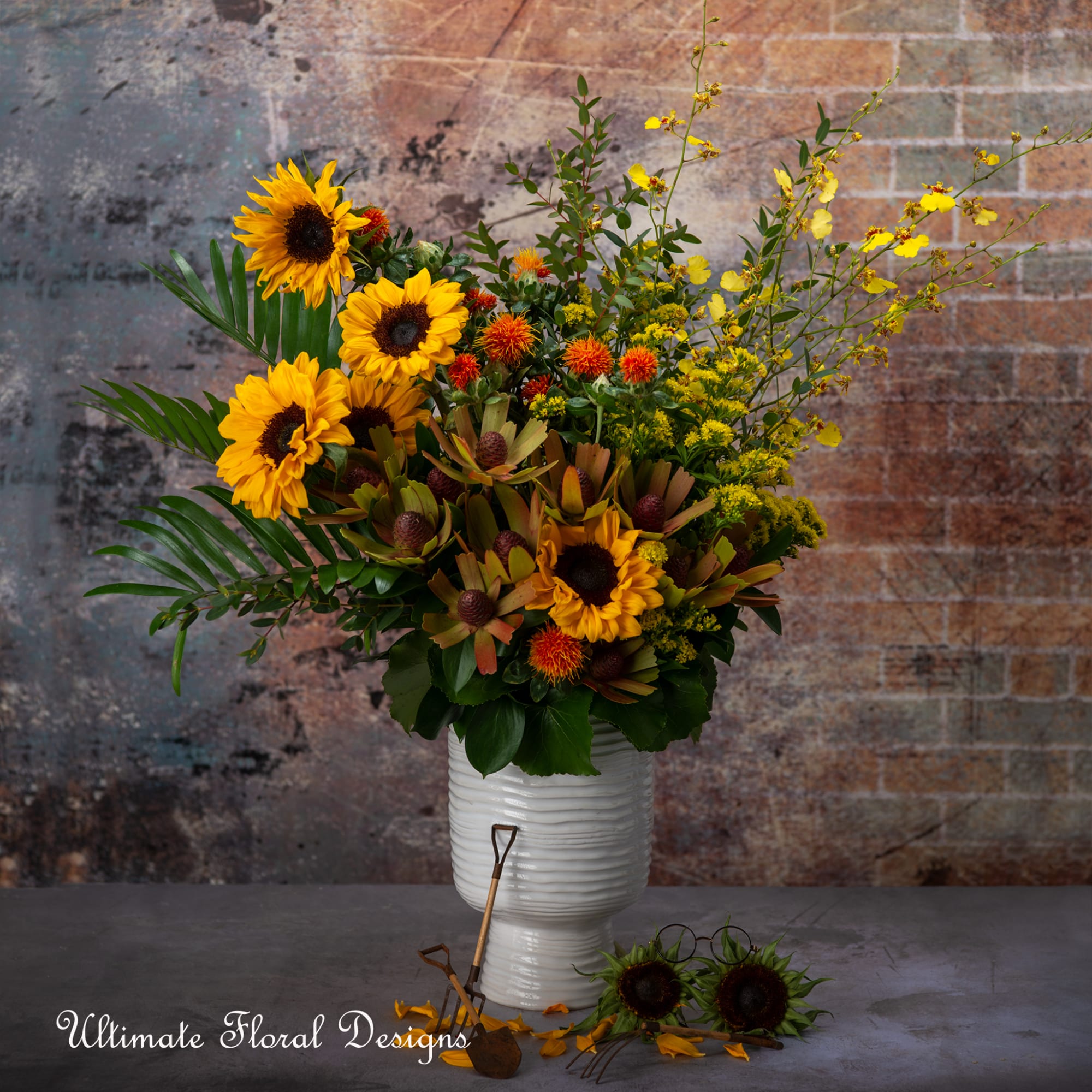 Sunflower arrangement in a white vase with yellow and orange accents