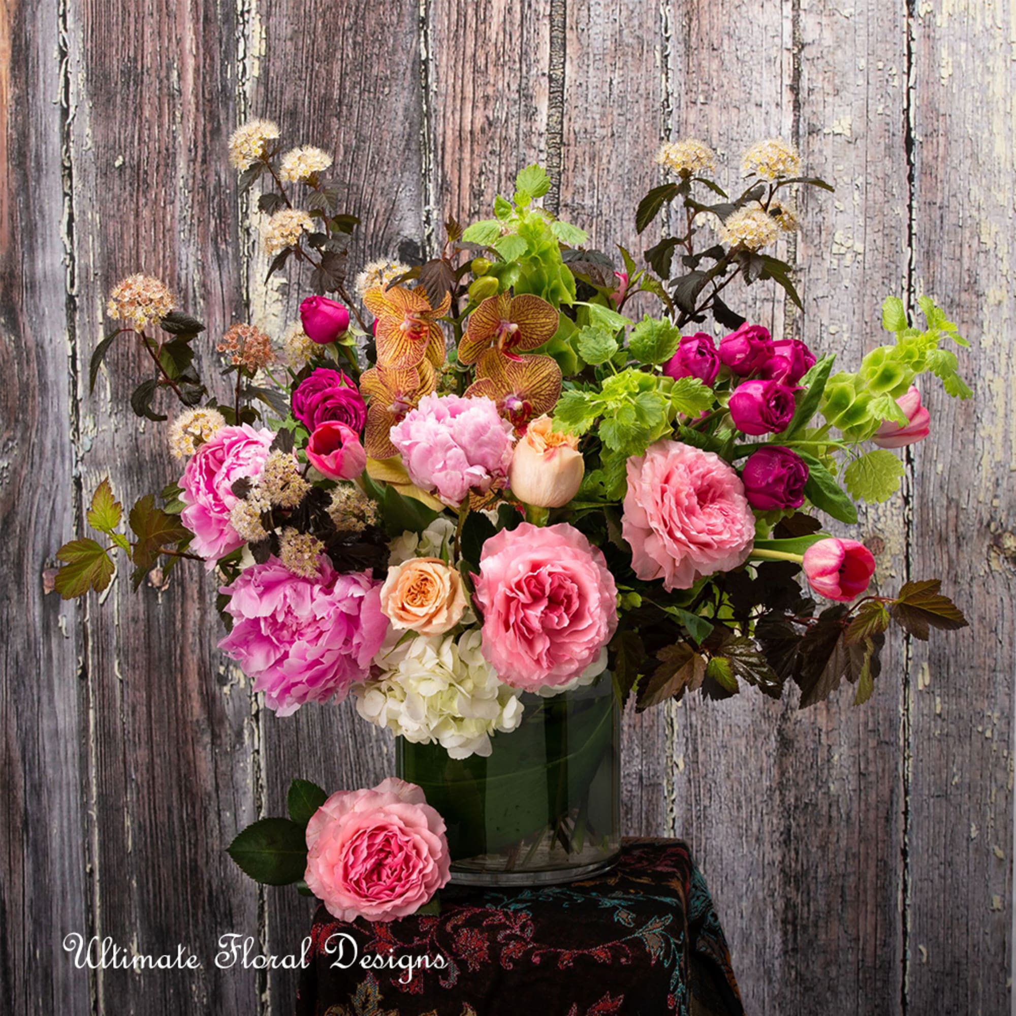 Mixed pink and peach flowers in a glass vase