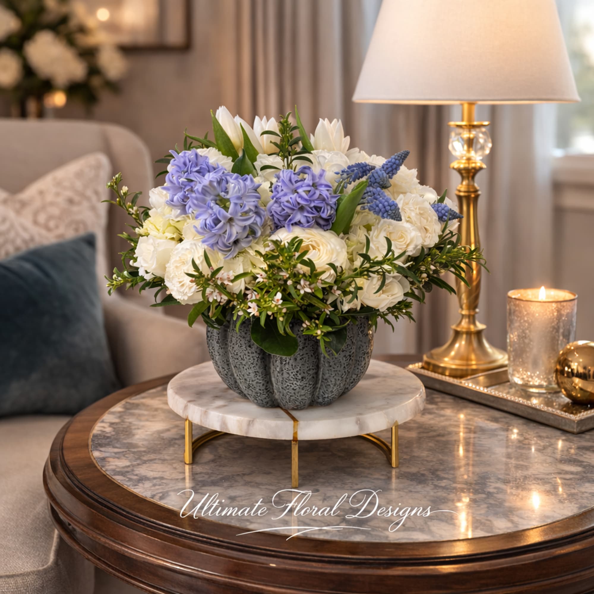 Blue and white floral arrangement in a gray vase on a table