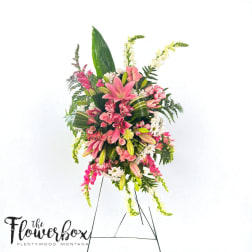 Tall pink and white floral standing spray on an easel