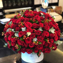 Large dome arrangement of red roses in a white hat box