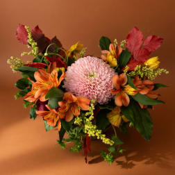 Pink chrysanthemum bouquet with orange alstroemeria and autumn leaves
