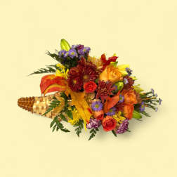 Mixed bouquet in a woven cone with orange, red, and purple flowers