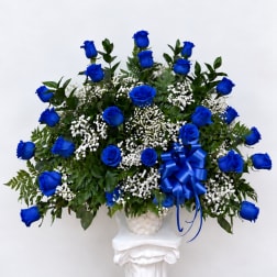 Blue roses in a white basket with a blue ribbon bow