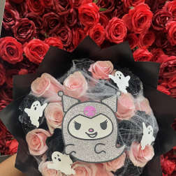 Pink rose bouquet with Halloween ghost decorations and a glitter cat topper