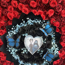 Black rose bouquet with blue baby's breath and butterfly accents