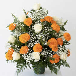White roses and orange marigolds in a green vase