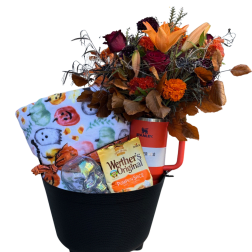 Fall gift basket with flowers, blanket, candy, and a red tumbler