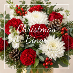 Christmas floral arrangement with red roses, white blooms, and pinecones