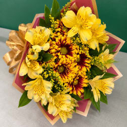 Yellow alstroemeria and red-yellow chrysanthemums in a wrapped bouquet