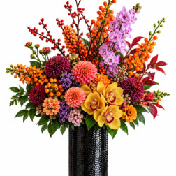 Colorful mixed flower arrangement in a black vase