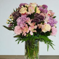 Mixed pink and purple bouquet in a clear glass vase
