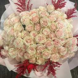 Large bouquet of pale pink roses with red filler accents