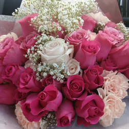 Bouquet of pink and white roses with small white filler flowers