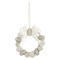 White decorative wreath ornament with a ribbon bow and hanging loop