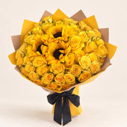 Bouquet of yellow roses and sunflowers wrapped in yellow and brown paper