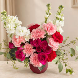 Pink and white floral arrangement in a round vase