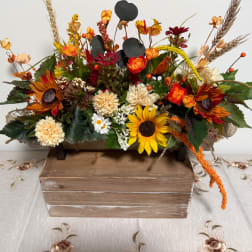 Autumn floral arrangement with sunflowers and mixed blooms in a wooden box