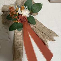 Small burlap floral corsage with roses and ribbon
