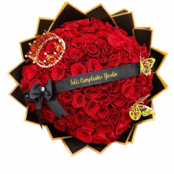 Heart-shaped bouquet of red roses with black and gold wrapping